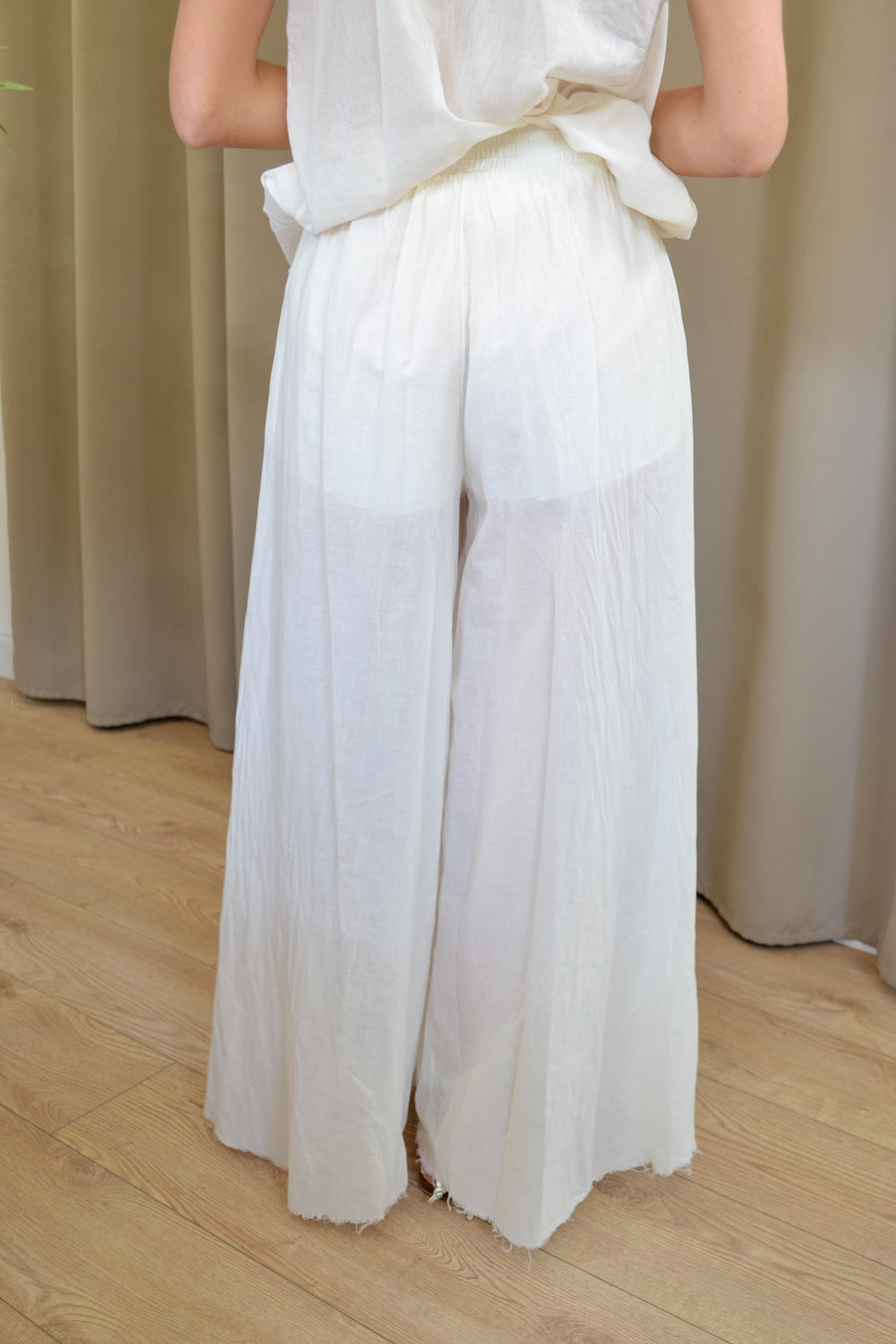Pantalone palazzo bianco in mussola di cotone con fondo sfrangiato posteriore — Margé Pomezia